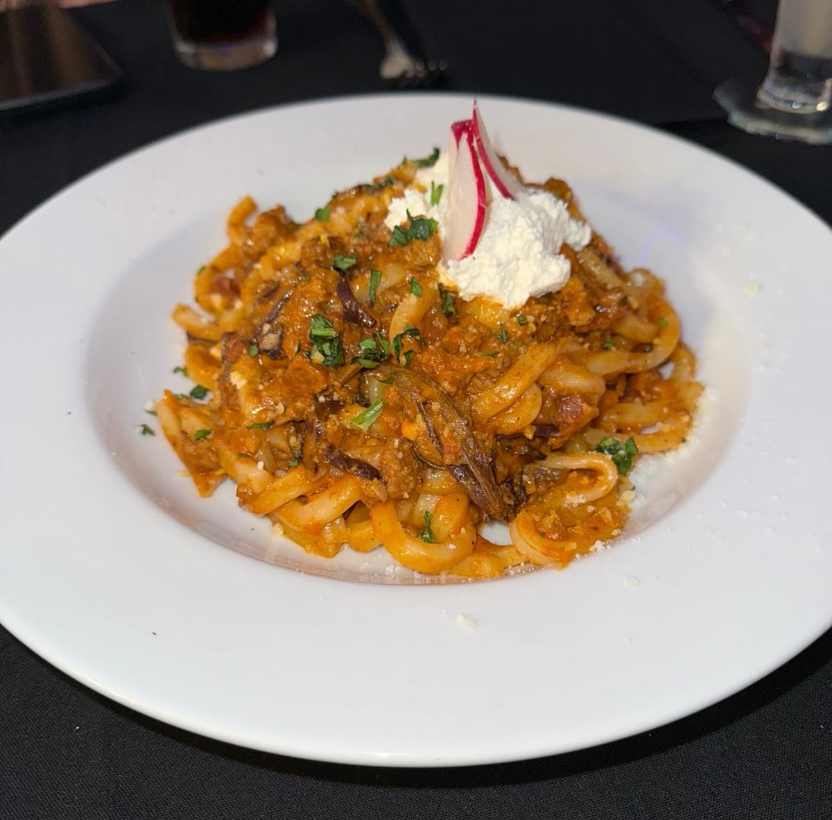 Udon noodle bolognese topped with miso whipped ricotta.