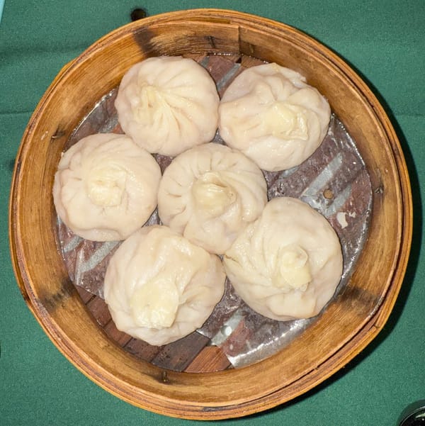 Steaming pork soup dumplings served at Hu's House restaurant in Colonie, New York