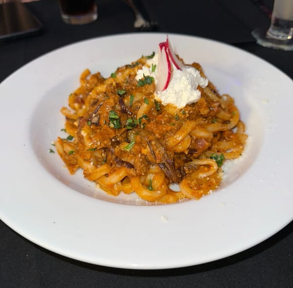 Udon noodle bolognese topped with miso whipped ricotta.